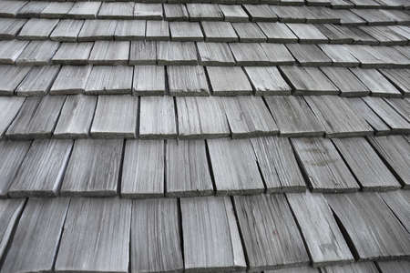 Wooden roofs are lined up for sun and background rain.