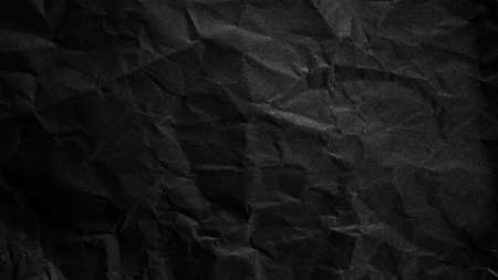 Textured crumpled black paper background.の写真素材