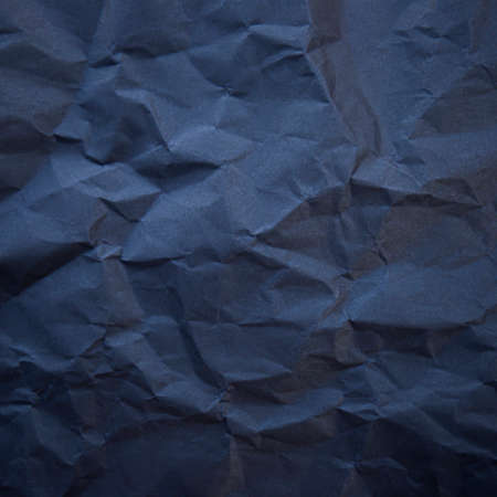 Textured crumpled black paper background.の写真素材