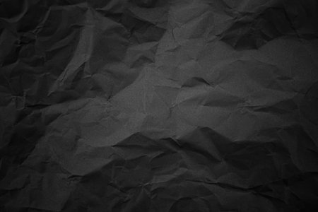 Textured crumpled black paper background.の写真素材