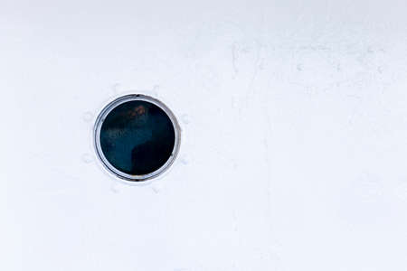 Circular window on the wall of the boat.