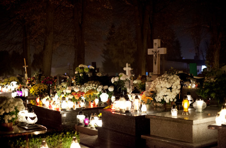 Candle flames illuminating  cemetery during All Saint's Dayのeditorial素材