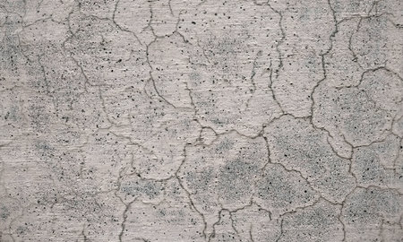 Texture of old concrete wall with cracks and scratches which can be used as a backgroundの写真素材