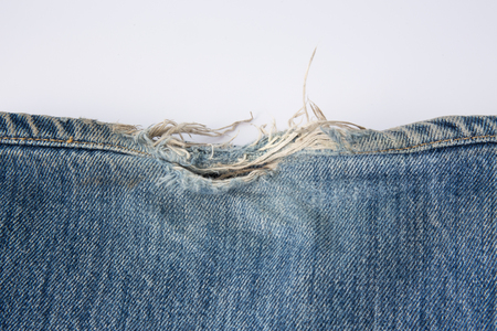 torn blue jean denim texture and backgroundの写真素材