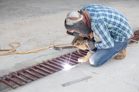 flash and spark from welding metal at construction site