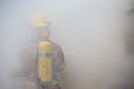 single fireman in operation surround with smoke