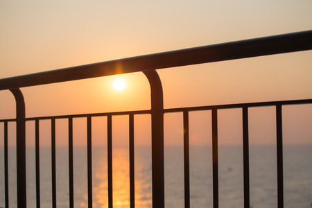 silhouette of room balcony with sea background in sunriseの写真素材