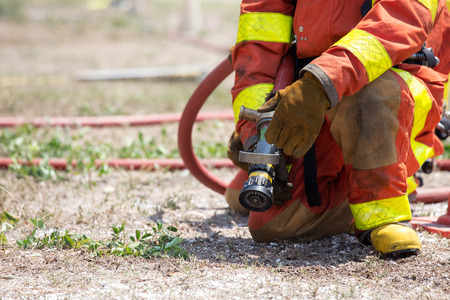 firefighters and buddy standby with fire hose  for fire fighter searching and rescue in training course with copy spaceの写真素材