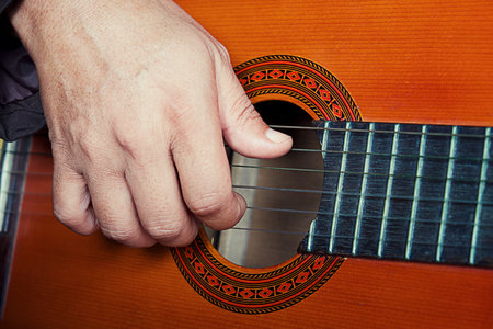 closeup playing the guitar vintage effect.の写真素材