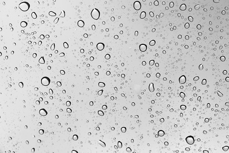 Water drop abstract on glass in rainy day and dark weather.の写真素材