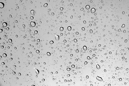 Water drop abstract on glass in rainy day and dark weather.の写真素材