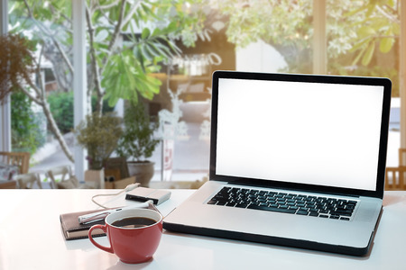 side view of the laptop is on the work table in a Home office with morning light and vintage tone.の写真素材