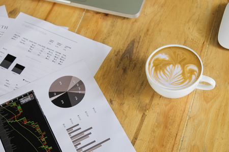 business documents with charts growth and coffee. workplace businessman