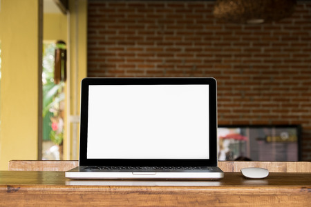 Laptop with blank screen on table of a cafeの写真素材