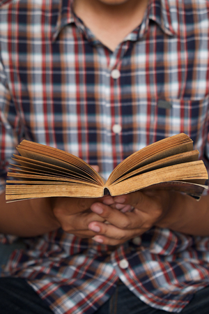 Young man reading a book,Vintage effect.の写真素材