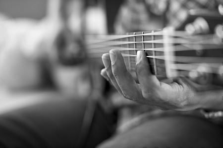 playing acoustic guitar, barre chord,selective focus,black and white tone.の写真素材