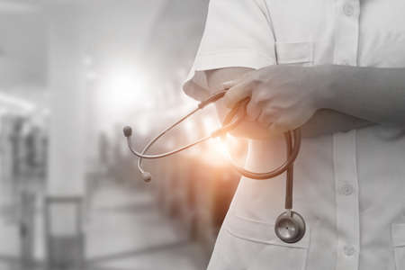 Doctor with stethoscope on hand in a hospital with selective color.の写真素材