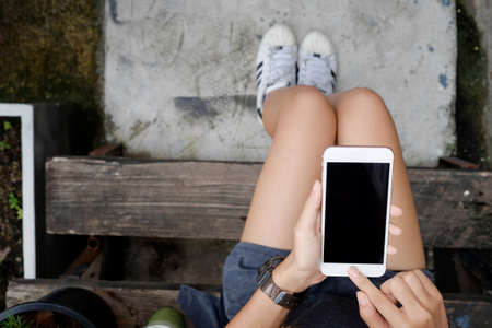 Woman using smartphone above top view.