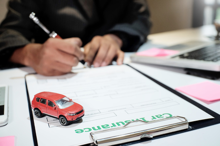 A Man Insurance broker offer protect your car , Insurance auto car concept and Insurance reimbursement vehicle Conceptの写真素材
