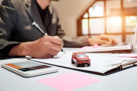 A Man Insurance broker offer protect your car , Insurance auto car concept and Insurance reimbursement vehicle Conceptの写真素材