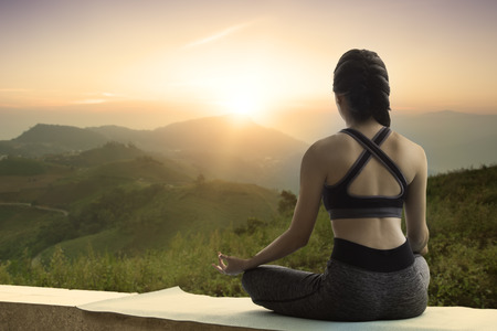 Woman Yoga relax in nature with copy space.の写真素材