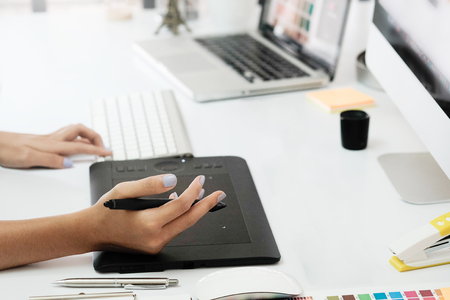 graphic design desk hand using mouse pan sketch device on creative desk.の写真素材