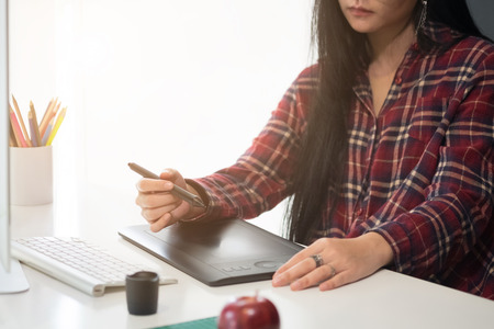 Creative woman working in creative office with computer and gadget or device on artist desk, graphic design concept.の写真素材