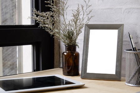 Mock up contemporary  :Empty frame photo on wood desk mock up on table.の写真素材