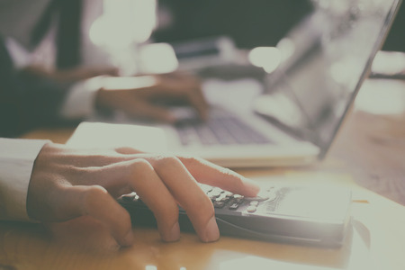 Finance concept, businessman calculate cost of product to startup new business.の写真素材
