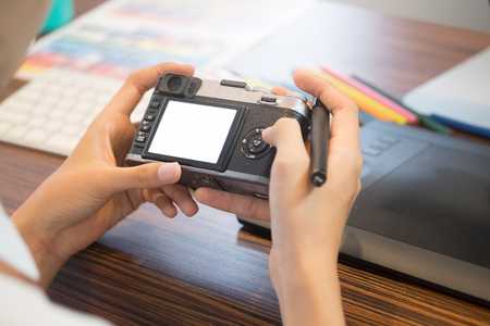 Closeup photography selective photo in camera with photographer table creative concept.の写真素材