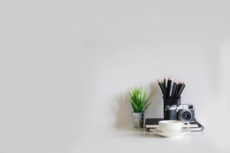 office supplies, camera,coffee cup plant decoration and pencils on with empty copy space for present something.の写真素材