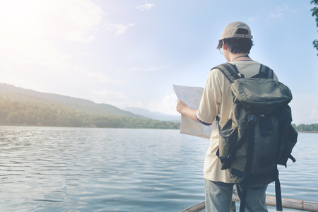 Travel concept,Man on lake and mountains view at holiday time.の写真素材