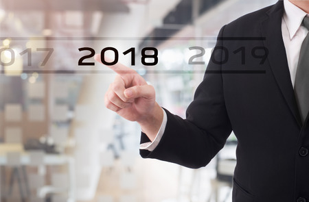 Businessman pointing year 2018 welcome year 2018. Business new year card conceptの写真素材