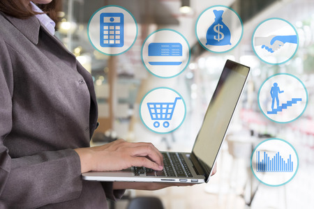 Businesswoman using laptop with icon of business.の写真素材