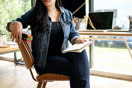 working woman sitting on chair and wearing jean.の写真素材