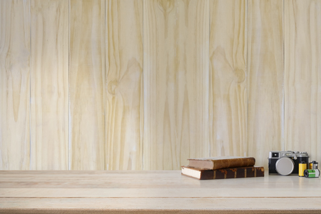 wood desk and wall with book old vintage camera with copy space for present product mockup concept.の写真素材