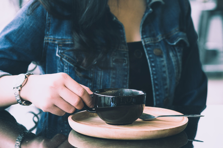 woman holding cup of hot coffee.の写真素材