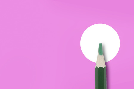 Paper and pencil Minimalist template copy space top view closeup macro photo of green pencil isolated on graphic in pink and white paper.の写真素材