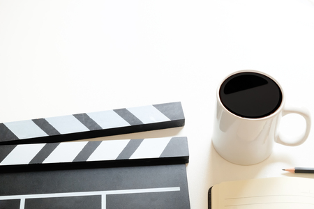 Office stuff with Movie clapper and coffee cup pencil notepad on table top view shot and copy space.の写真素材
