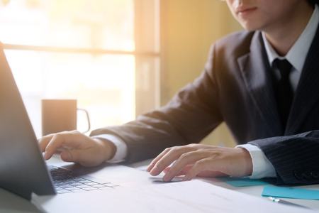 Businessman working with laptop computer in home office.