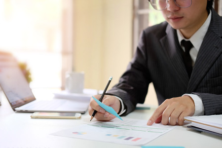 Audit man working with finance data on office business workplace.の写真素材