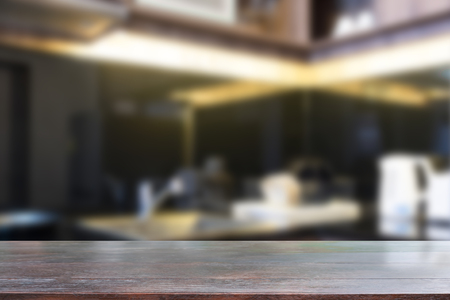 Wood desk table dark tone on kitchen room blur background.の写真素材