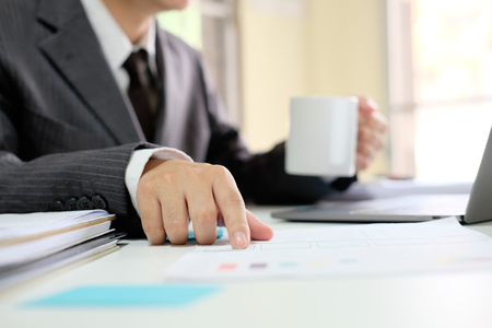 Business working with document paper and drinking coffee cup.の写真素材