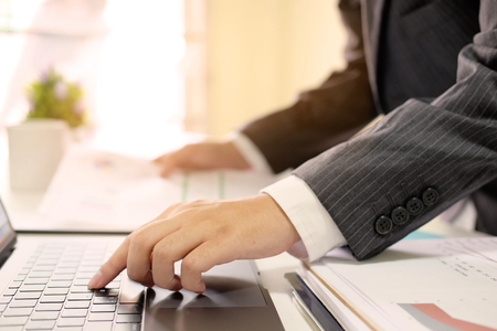 Businessman working with laptop computer in home office.の写真素材