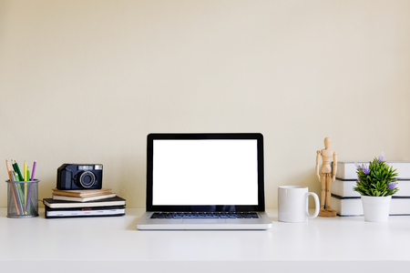Mockup blank screen computer laptop on desk. Workspace with laptop and office supplies.の写真素材