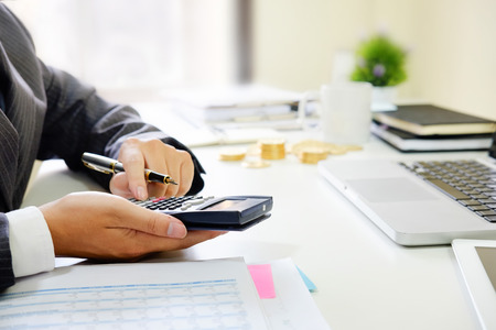 Close up business calculate finance data document paper with calculator.の写真素材