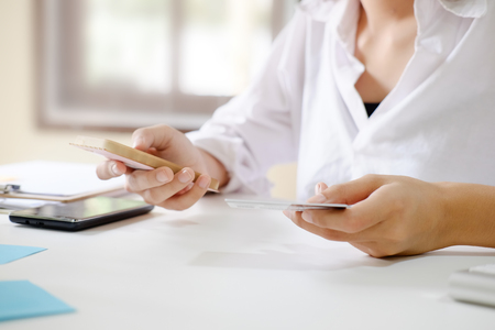 Woman hands using smartphone shopping online and credit card holding on.の写真素材