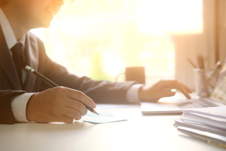 Businessman analysis data working on table with morning light.の写真素材