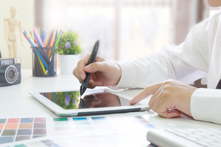 Graphic designer working with digital tablet cropped shot photo.の写真素材