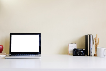 Mockup blank screen computer laptop on desk. Workspace with laptop and office supplies.の写真素材